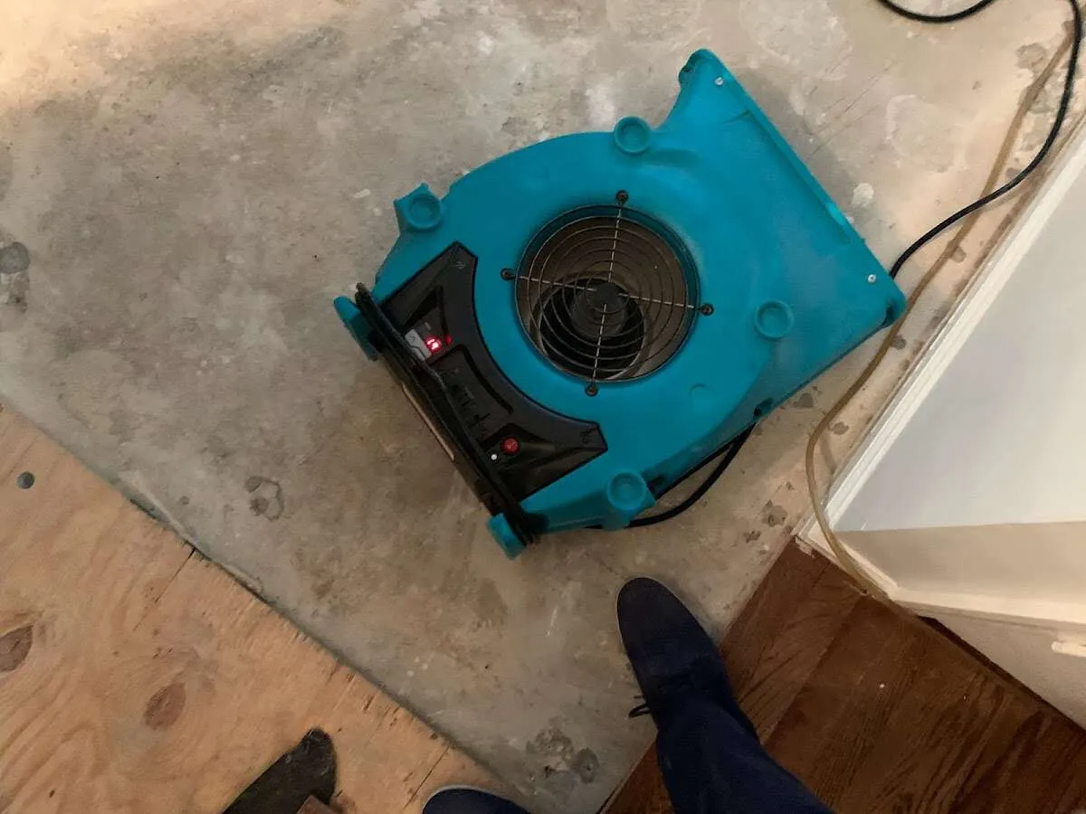 Air mover drying subfloor during Commercial Water Damage Restoration in Johnsburg